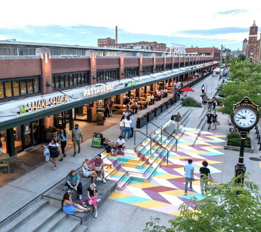 The Terminal in Pittsburgh's Strip District at golden hour, with painted plaza steps and outdoor diners